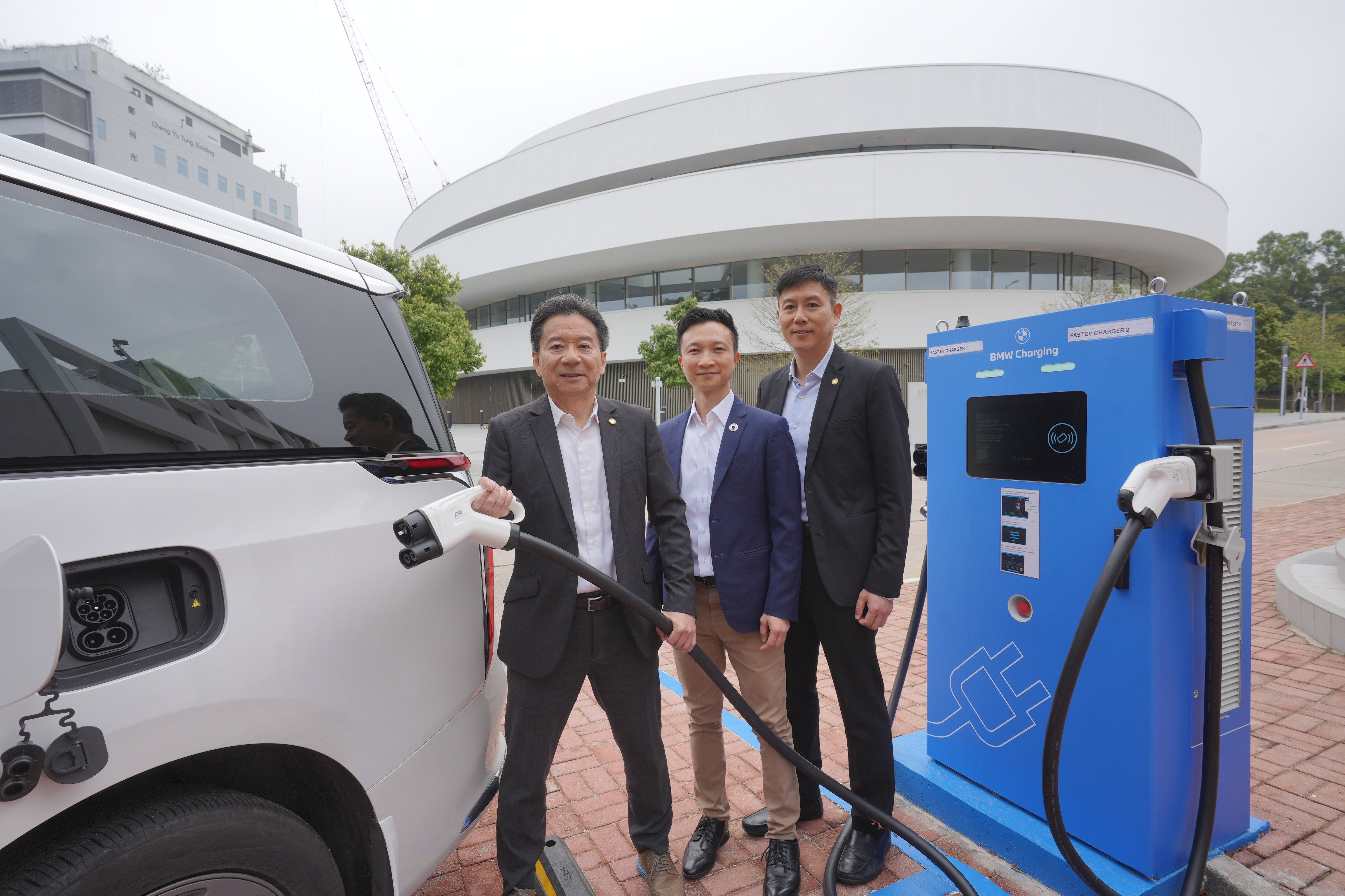HKUST Vice-President for Administration and Business Prof. PONG Ting-Chuen (left), Director of Campus Management Office Mr. Alex CHEUNG (right) and Acting Director of Sustainability/Net-Zero Office Mr. Marcus LEUNG-SHEA try out the newly launched fast EV charger this week.