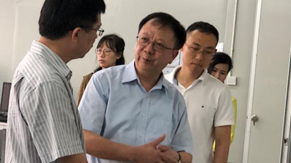 Prof. Wen (Middle) and Dr. Gao (right) introduce the theories behind their novel detection device in their research base at Shenzhen. 