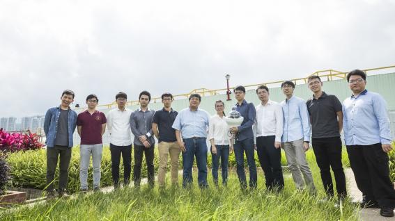 Prof. Wang (Left sixth) and his research team are developing the fourth generation of the sensor that can harvest energy from solar panel and conduct data analytics by AI.