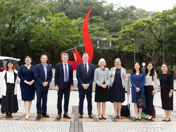 Photo of the University of Queensland delegation in front of the iconic “Red Bird” sculpture at the Piazza.