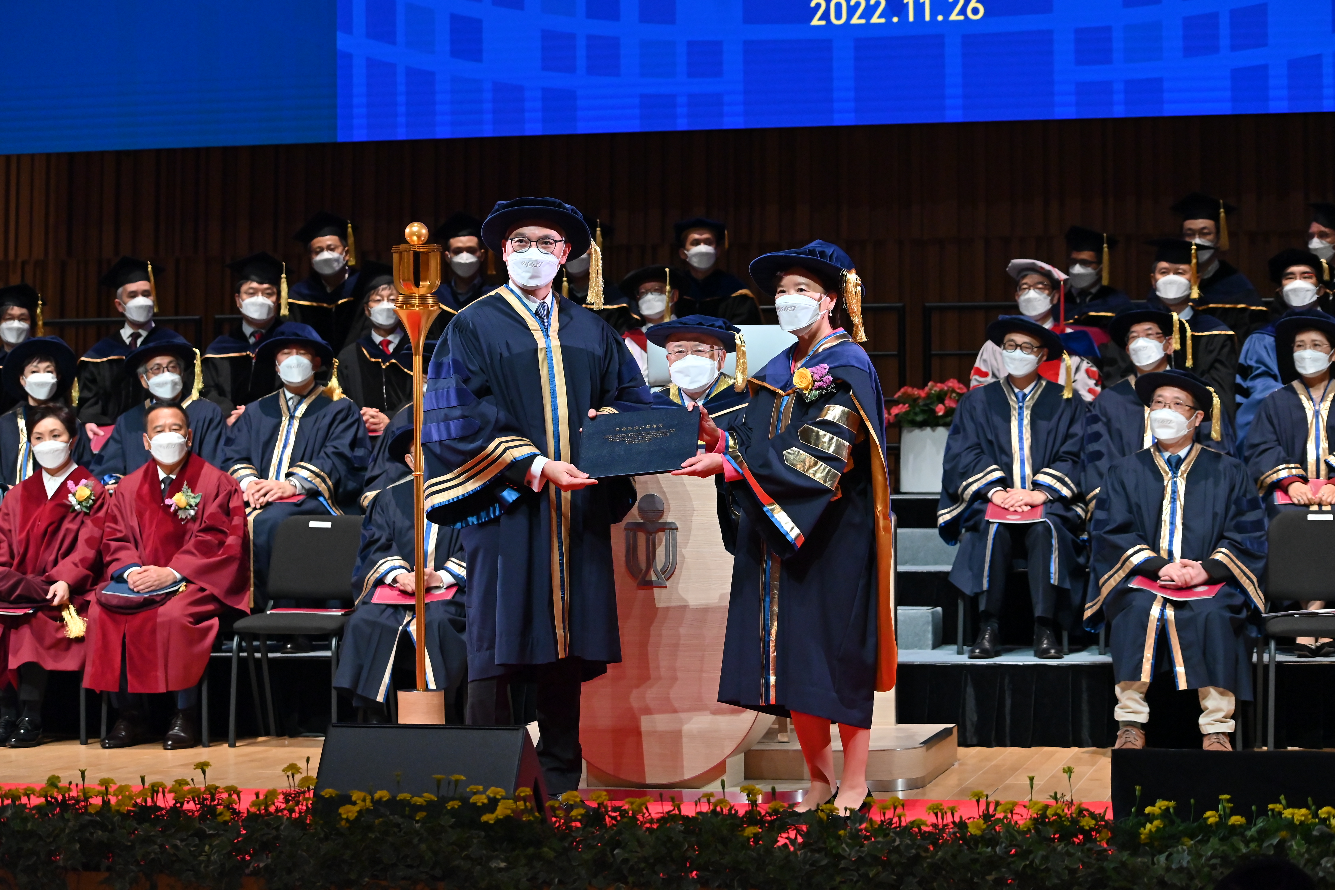 HKUST Council Chairman the Hon. Andrew LIAO Cheung-Sing (middle) installs the new President Prof. Nancy IP (right).  University Treasurer Mr. Stephen YIU Kin-Wah (left) presents her a copy of the University Ordinance and the Seal of the University