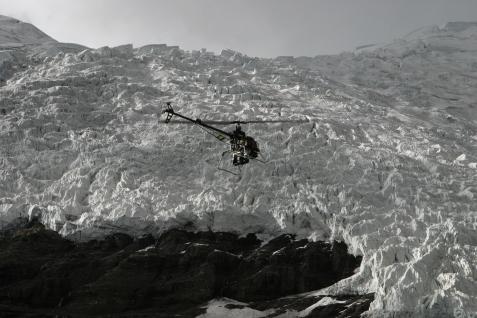  The helicopter flying over a glacier