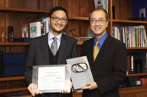 Dr Jack Lau (left), Chairman of Perception Digital Limited, presents the Company’s commemorative share certificate with serial number 001 and a product model of “Live Lite” – an MP3 player that monitors heart rate and other biometric features – to HKUST President Tony F Chan.	