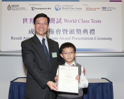 Tony Lam, Director of the World Class Test Asia Center at HKUST, presents a certificate to 7-year-old Mannix Chan, the youngest candidate to achieve distinction in both the Mathematics and Problem Solving papers in the Age 8-11 test.	